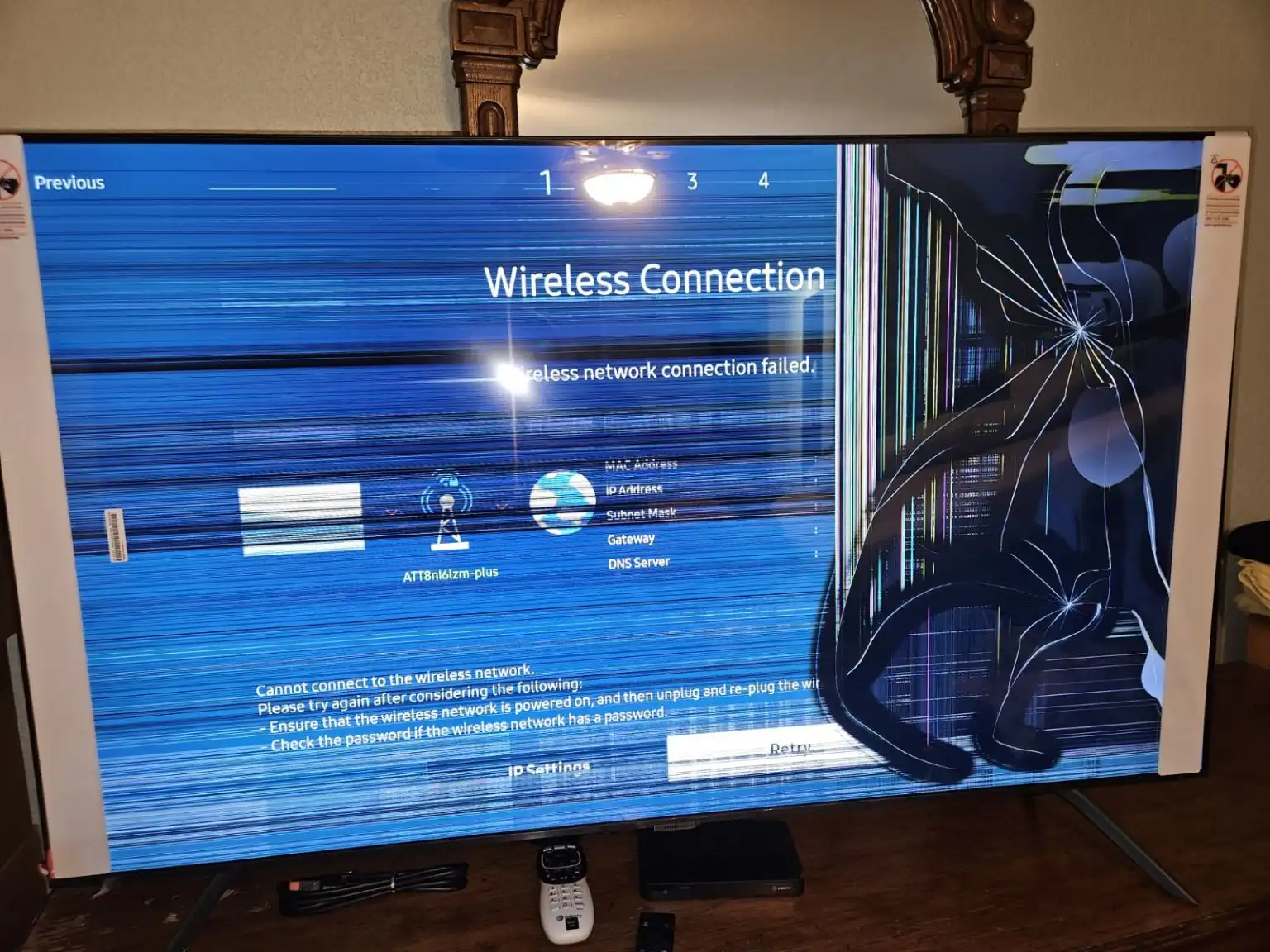 Close-up of a Samsung TV with a visible crack running across the screen